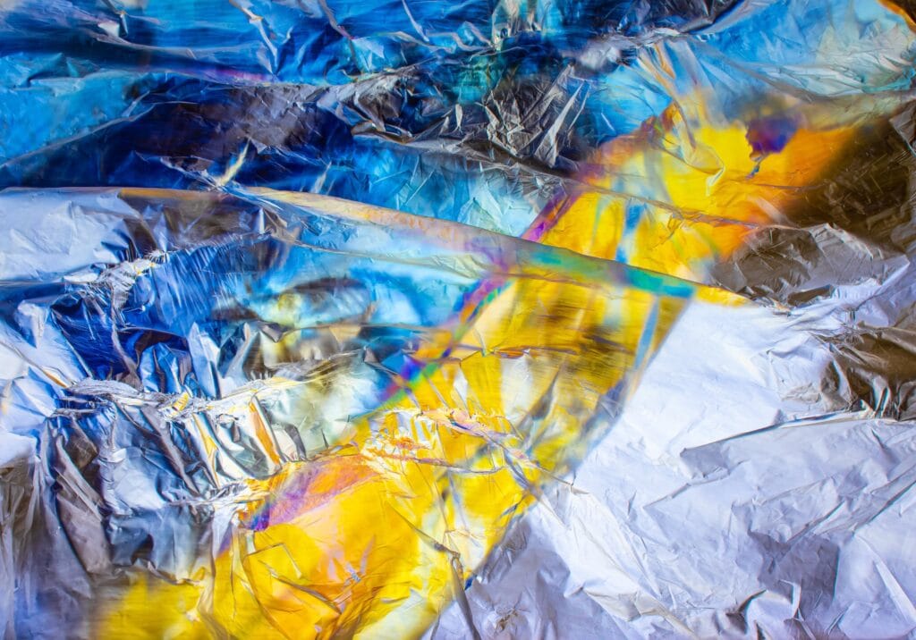 Amazing coloured patterns in a piece of stretched plastic bag under polarised light