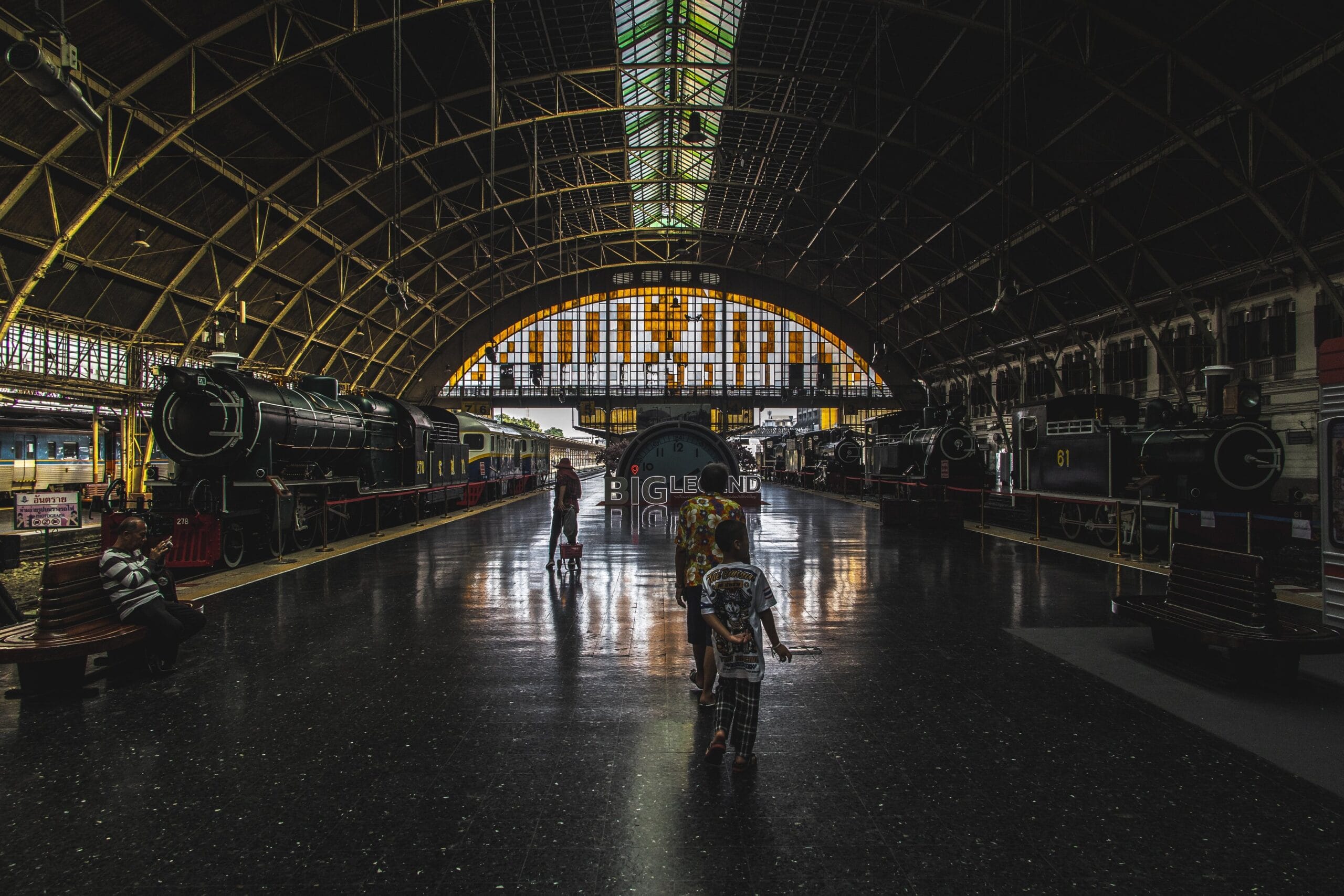 Hua Lamphong station concourse with the arched roof, stained glass windows and historic trains