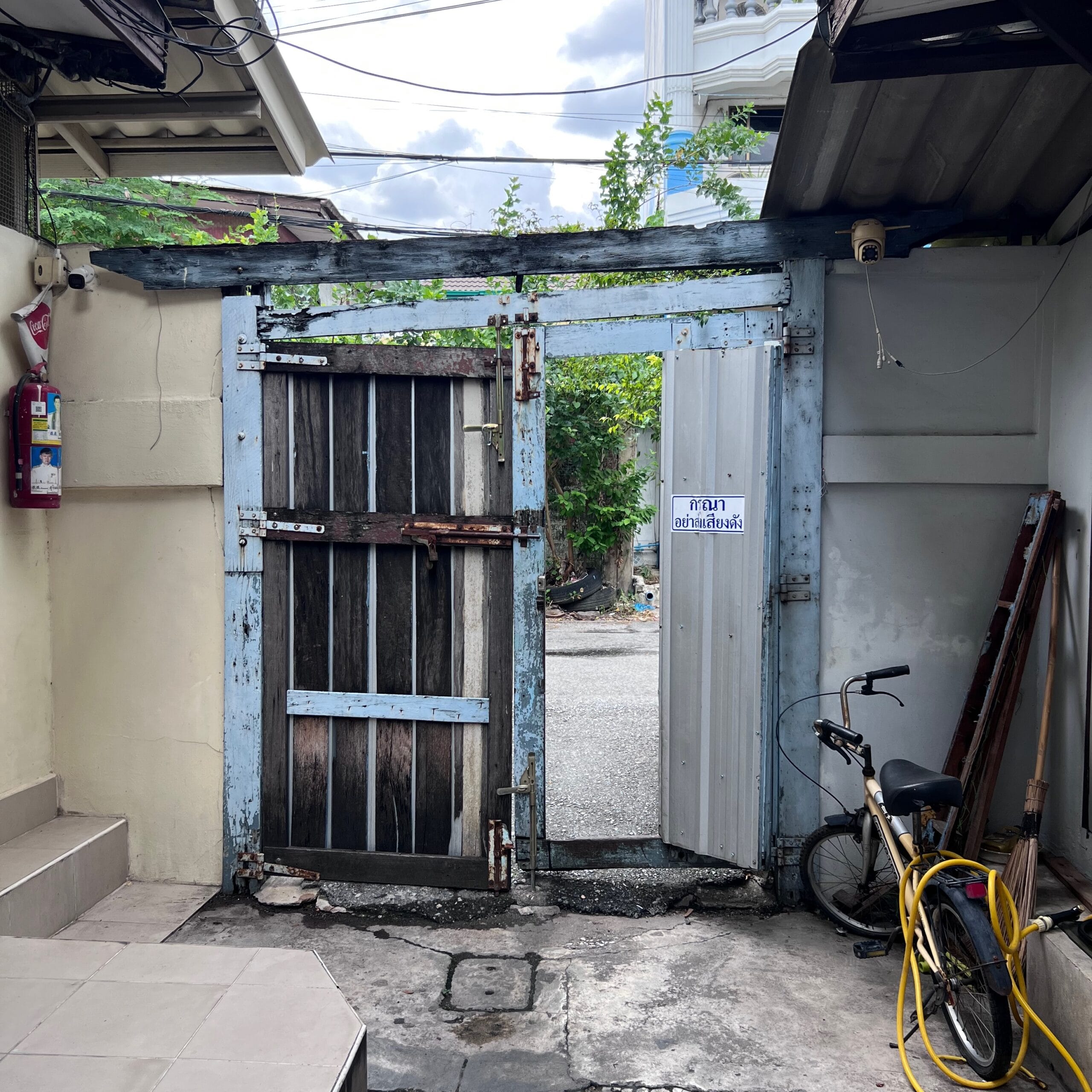 A door linking two narrow alleys in Bangkok