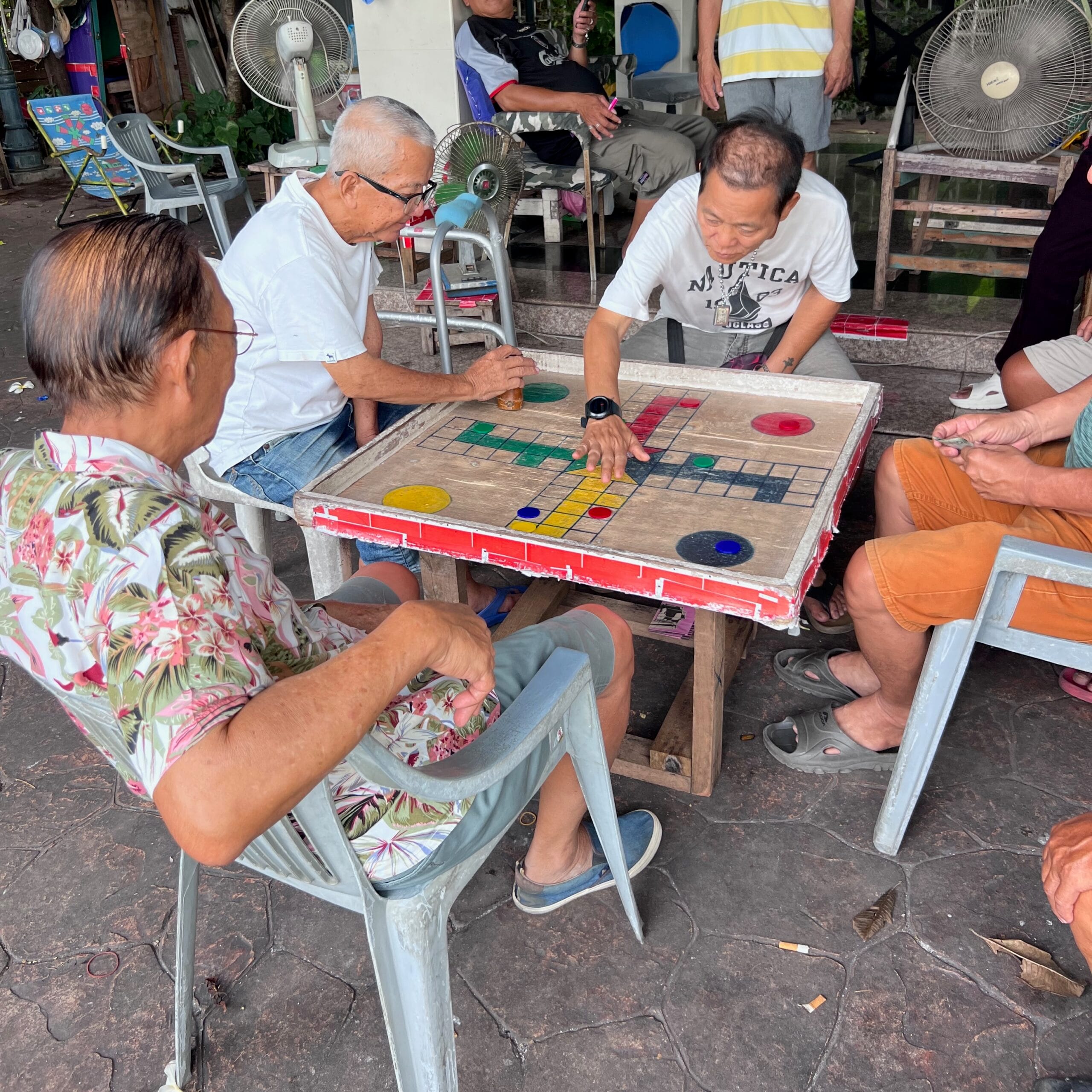 Thai men playing board games in Bangkok