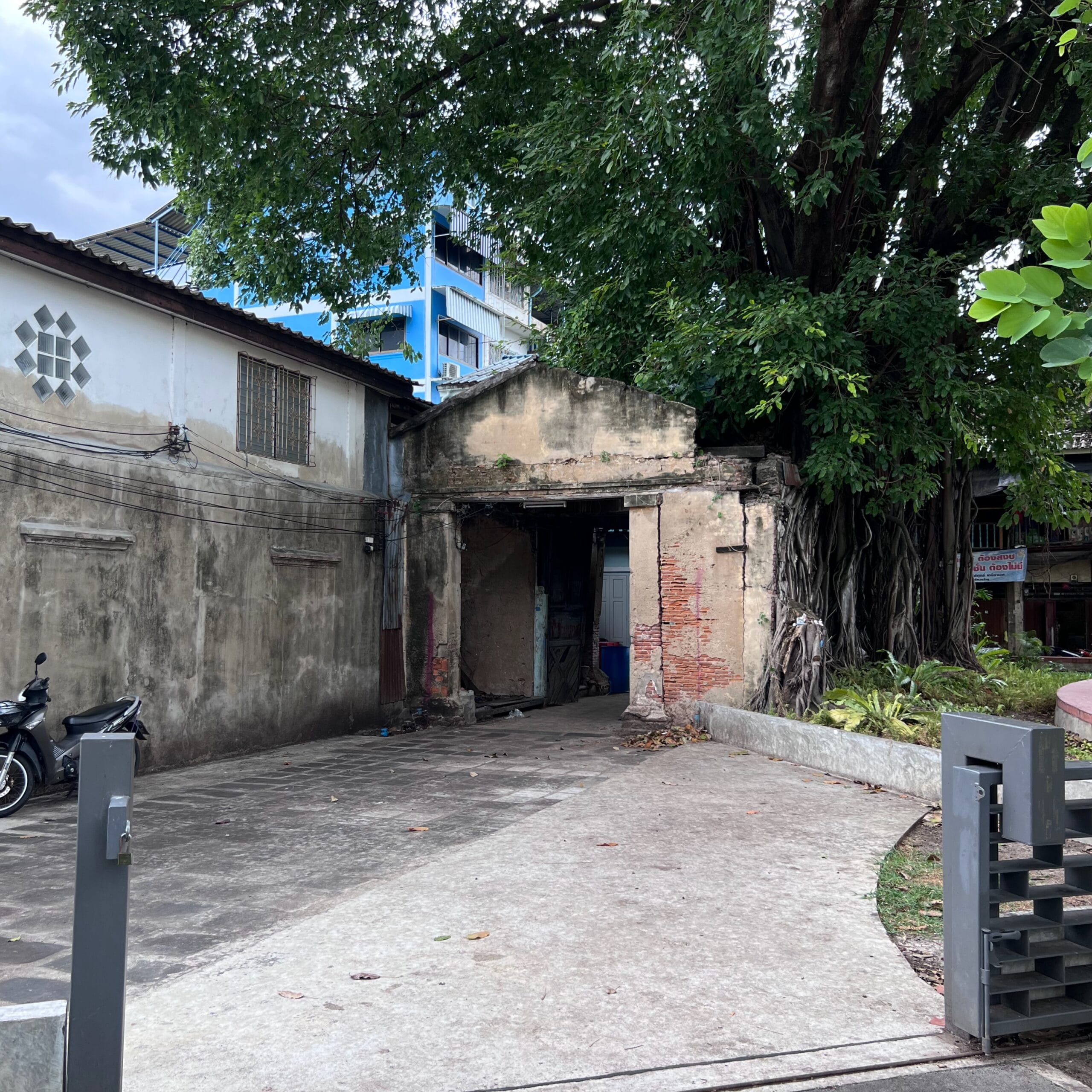 Old wall and arch gate over in alley in Bangkok