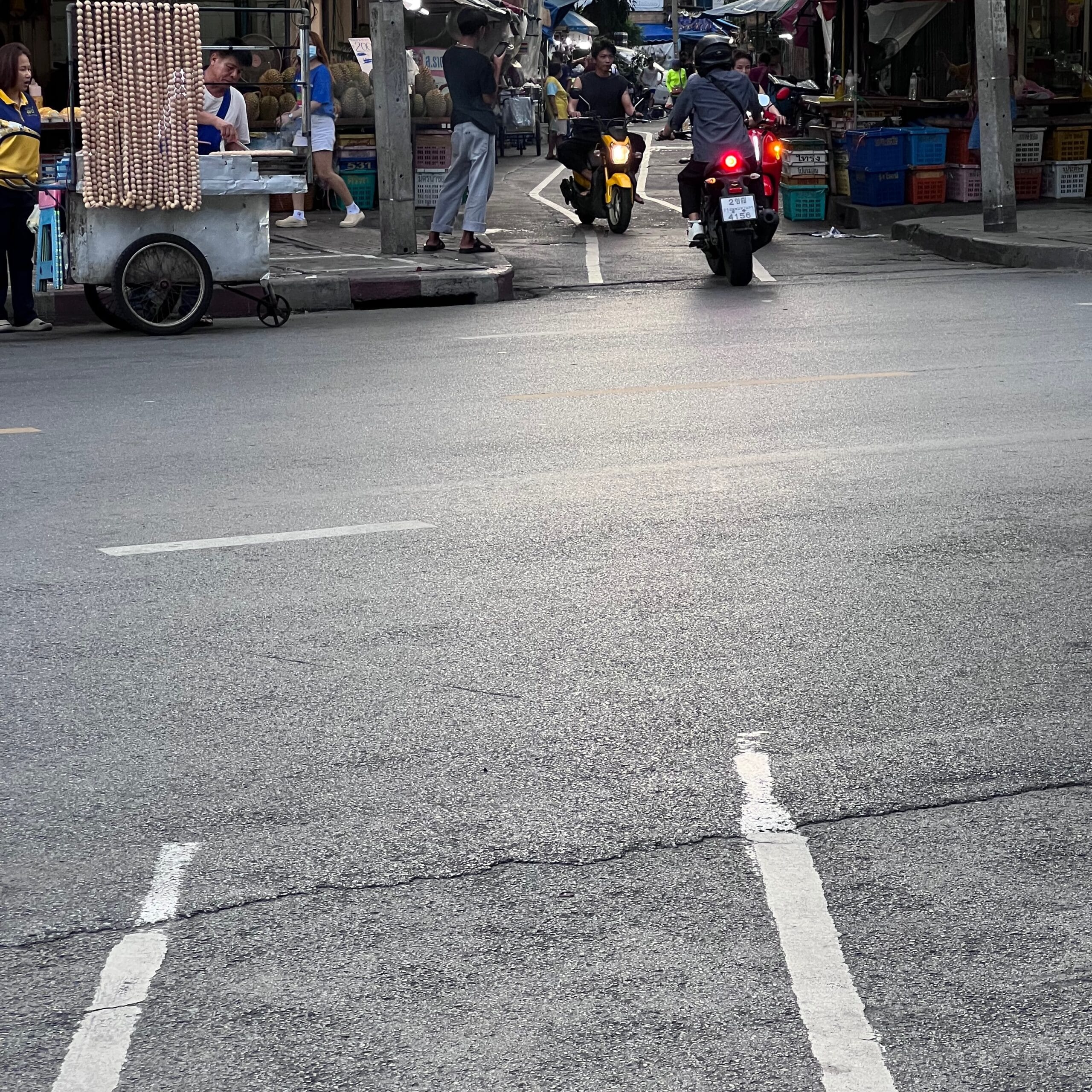 Following white lines in Bangkok's narrow alleys.