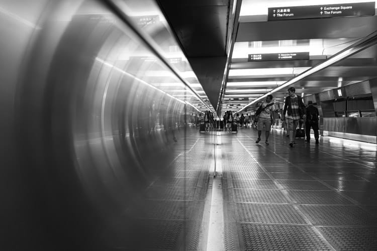Futuristic effect with the camera touching the metal side of a city walkway – monochrome