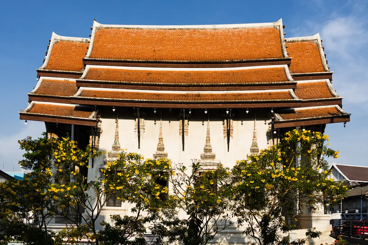 The abandoned temple of Wat Phumarin Ratchapaksi glowing orange in the late afternoon sunlight.